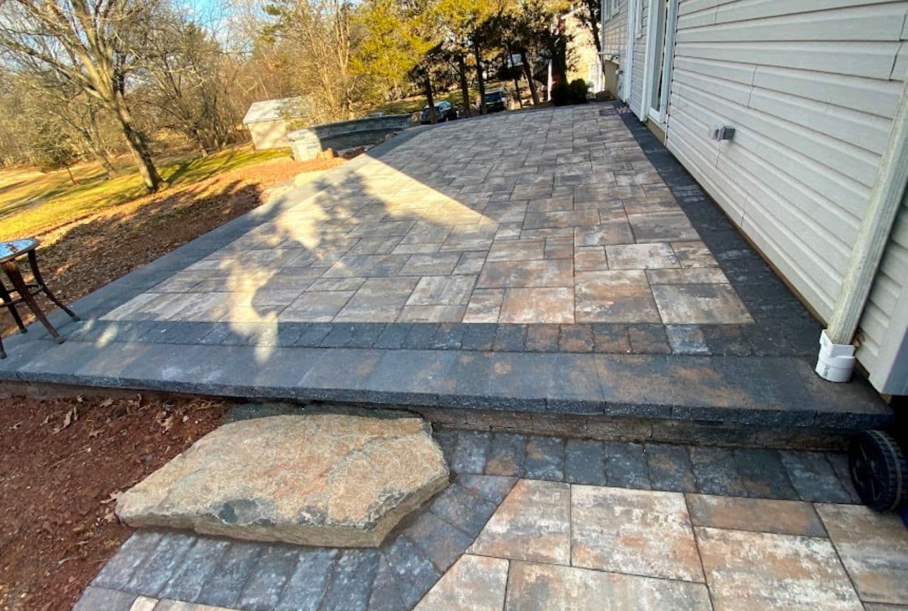Stone patio and curved walkway installed by MGM